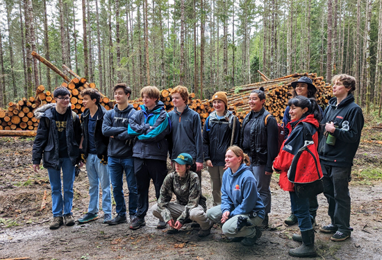 National Honor Society students from Kingston High School with their teacher Ivonne Heapy in front of ecologically thinned forest 
